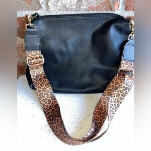 Joy Susan black crossbody bag with an adjustable leopard print "guitar" strap